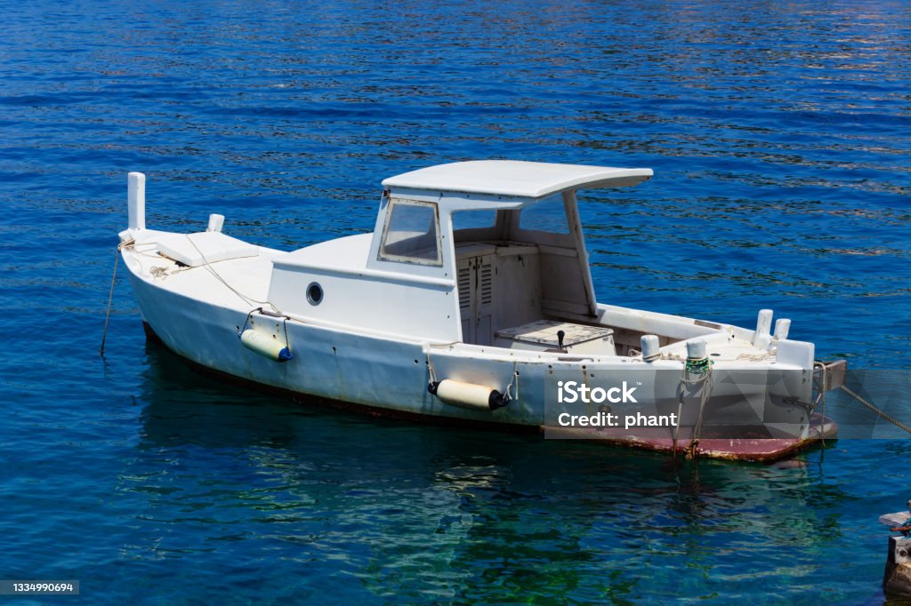 boat moored at the wooden pier in harbour of Losinj town, Croatia.